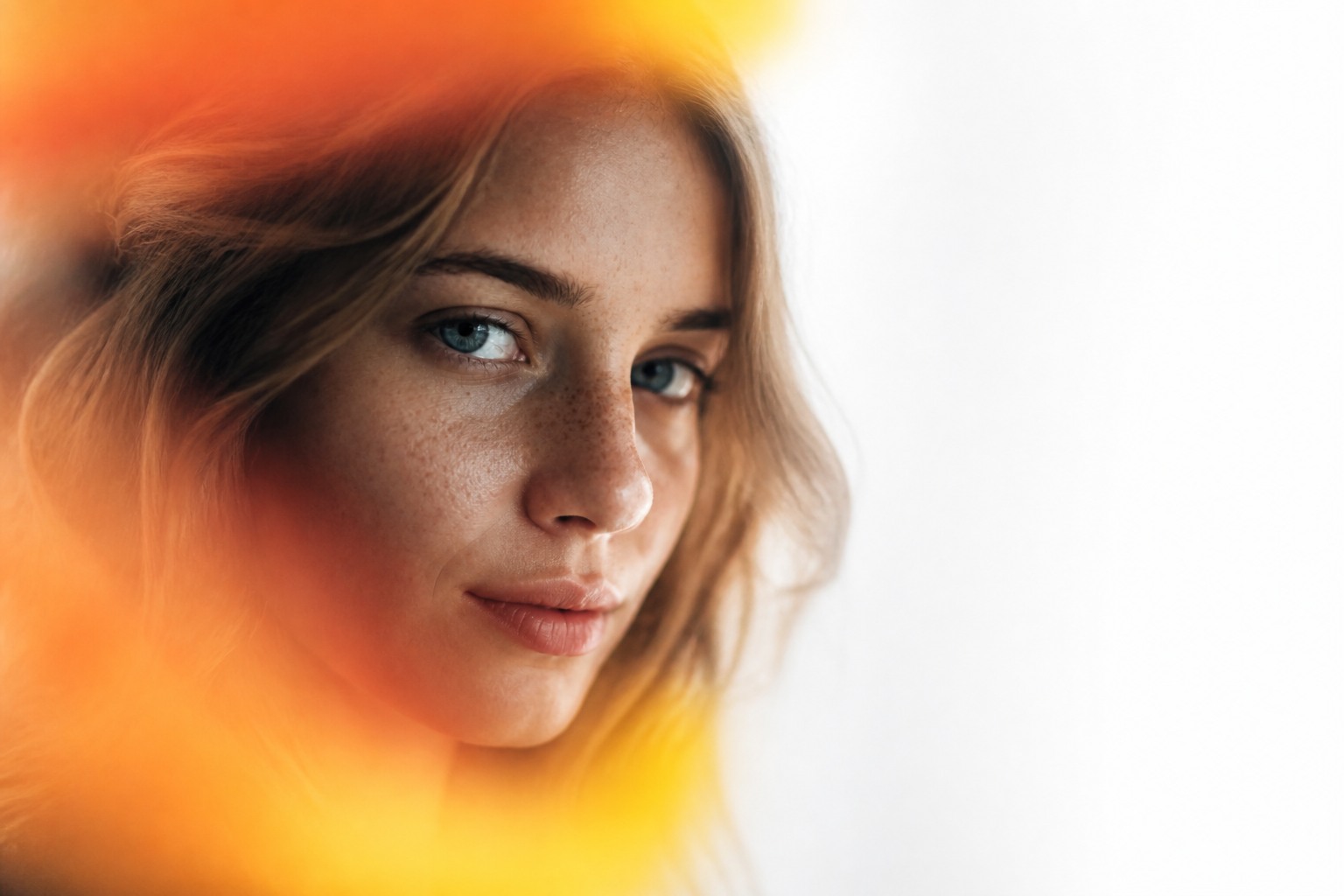A woman behind a veil of warm orange light — seeing without being seen.